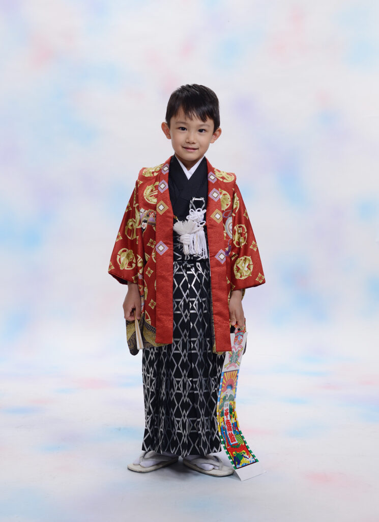 静岡市の写真館で千歳あめをもって5歳のお祝いの写真撮影をする男の子